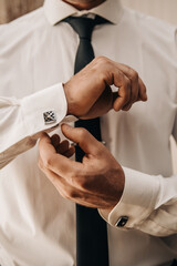 Background man fastens buttons on his shirt 