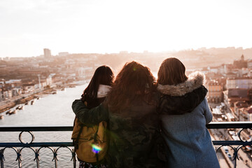 Three happy friends Porto bridge sightseeing at sunset. Travel, friendship and Lifestyle - obrazy, fototapety, plakaty