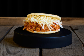 arepa stuffed with cheese and shredded chicken