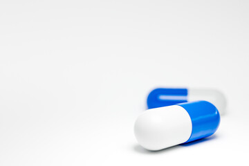 2 blue medical pill capsules on white background. 3d render medical capsules
