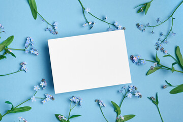 Invitation or blank greeting card mockup with forget-me-not flowers