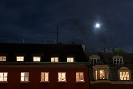 Moon over multistorey townhouses at night