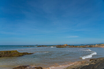 Fototapeta na wymiar The shore with rocks at Bentota Beach, Indian Ocean, Sri Lanka