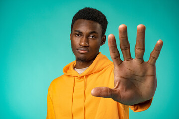 Young african american man over studio background doing stop sing with palm of the hand