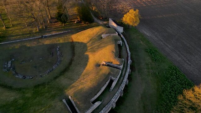 Drone view of Gallo-Roman ruins of Champlieu during a beautiful winter sunset. 360 degrees aerial shoot of an ancient amphitheater close to Orrouy city, department Oise, region Hauts-de-France