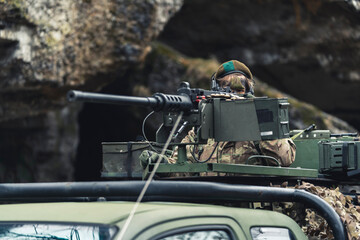 Newbie hiding like a wimp behind a machine heavy duty gun. High quality photo