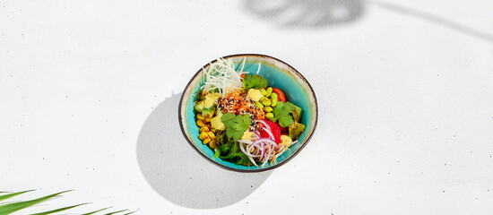 Hawaiian cuisine - Poke bowl with salmon, avocado, edamame and vegetables. Pokebowl in ceramic dish...