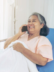 Elderly patients in hospital bed patients using smart phone call to descendant relatives feel happiness - medical and healthcare concept