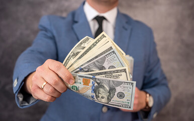  businessman in suit giving cash money us dollars