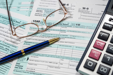 return U.S tax forms 1040 with pen calculator and glasses,  business financial concept