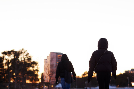 Two people walking in residential district