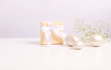 Easter mother-of-pearl eggs, gift box, hepsophila branch on a white background