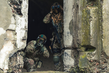 Cautious contingent soldiers watchdogging enemy lines . High quality photo