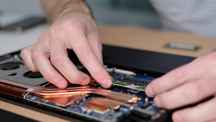 Unrecognizable engineer pulls out the RAM. Electronic renovation, business, occupation concept