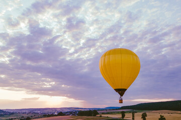 air balloon with basket above lavender field