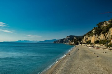 beach of fine sand with the waves of the sea that bathe the coast of western Liguria, in varigotti italy