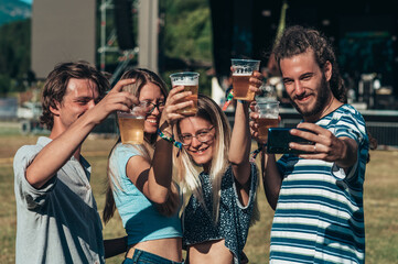 Friends at summer music festival taking selfie with a smartphone