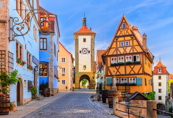 Fototapeta na wymiar Rothenburg ob der Tauber, Bavaria, Germany. Medieval town of Rothenburg on a summer morning. Plonlein (Little Square) and the two towers of the old city wall.