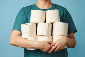 Woman holds toilet paper rolls, close-up