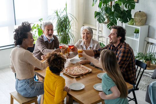 Happy multiethnic multigeneration family with husband, wife, children, grandfather and grandmother