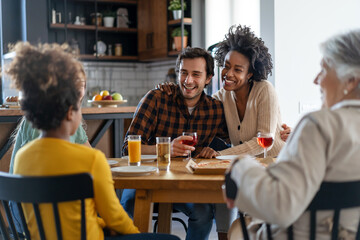 Multiethnic diverse extended family dining and toasting together