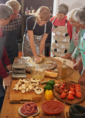 Food is essential to life, therefore, make it good. Shot of a group of seniors attending a cooking...