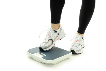 Female legs in sportswear and scales isolated on white background