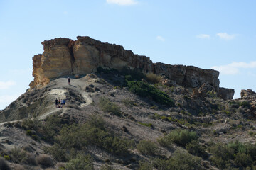 Fototapeta na wymiar People on the footpath leading up to Il-Qarraba promontory at Ghajn Tuffieha Bay, Malta.