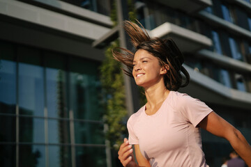 Fototapeta premium Fit athlete woman in sportswear outdoors. Young woman jogging outside.
