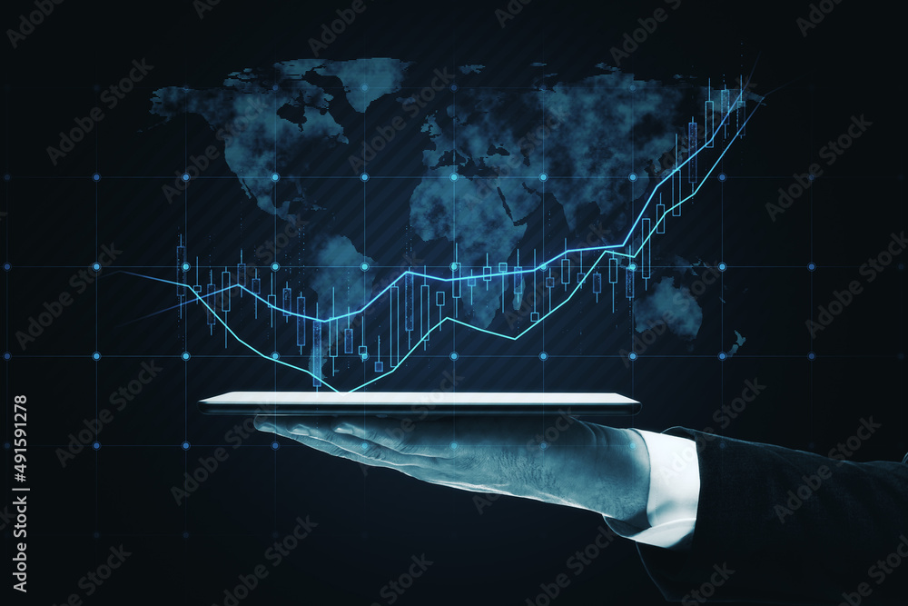 Poster close up of hand holding pad with global candlestick forex chart on dark background. trade, finance 