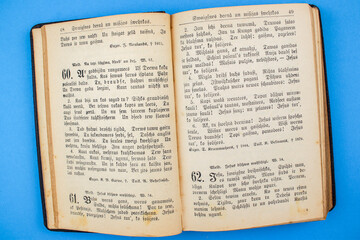 Old, Vintage Bible book on blue background