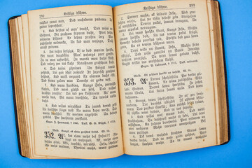 Old, Vintage Bible book on blue background