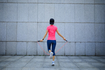 Fitness asian woman jumping rope - obrazy, fototapety, plakaty