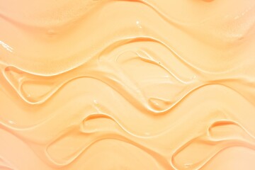 Liquid gel cosmetic smudge yellow orange mango background
