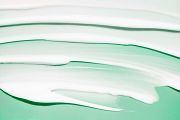 Cosmetic face hair body moisturizing or nourishing cream texture green colored background