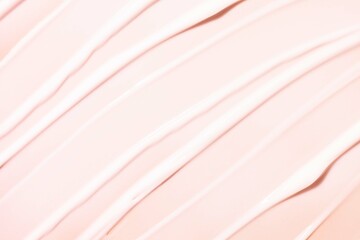 Cosmetic face hair body moisturizing or nourishing cream texture beige orange colored background