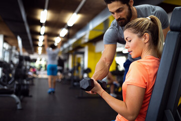 Portrait of happy fit group of people working out in gym together