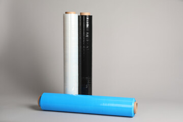 Rolls of different stretch wrap on light grey background