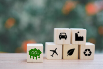 green CO2 emission reduction icon on wooden cubes with blur blocks for  CO2 emission ,green...