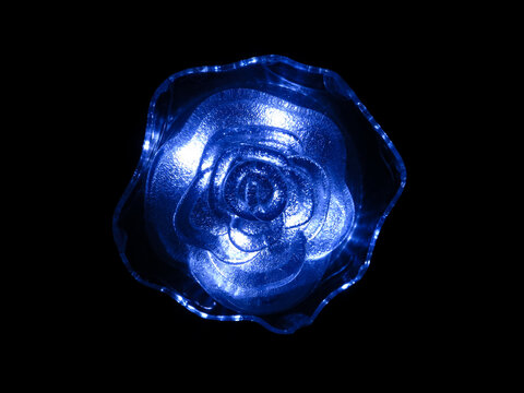 Blue neon rose on a black background.