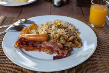 Breakfast with Bacon, Pork Sauces and Fired rice with egg 