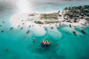 Top view or aerial view of Beautiful crystal clear water and white beach with long tail boats in summer of Zanzibar island - obrazy, fototapety, plakaty