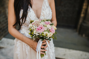 Detail of bride holding bridal bouquet stock photo.