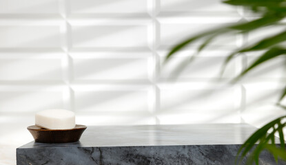 Marble table in the bathroom with free space, shadows of light on the tiled wall 