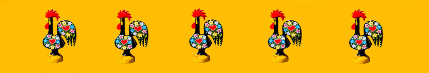The colorful rooster (Galo de Barcelos) on isolated yellow background