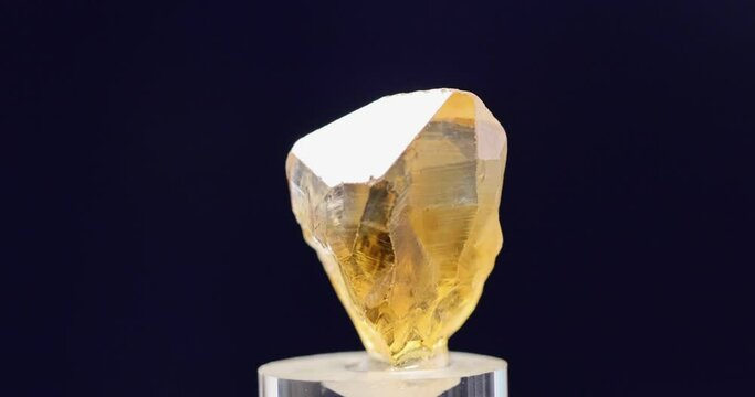 Macro close up citrine (quartz) mineral gemstone on dark blue background