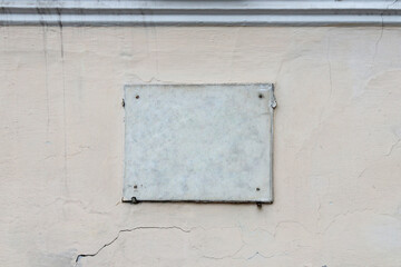Empty marble slab on the wall of an ancient stone building, space for text, copy space.
