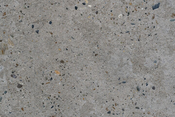 Texture of clean and flat concrete surface. Monolithic concrete wall or floor with inclusion of multicolored pebbles, high resolution.