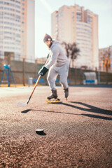 Hockey player training outside without ice - summer hockey training dribbling the puck