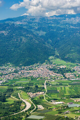 Aerial view of Sugana valley (Valsugana), small town of Levico Terme on the coast of Levico lake and mountain range of Lagorai. Tourist resort in Trento province, Trentino Alto Adige, Italy, Europe.